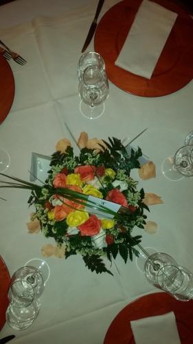 a white table with a bouquet of flowers on it at San Lorenzo Si Alberga in Camigliatello Silano