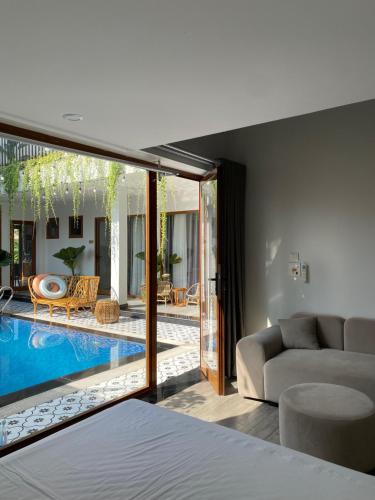 a bedroom with a swimming pool and a living room at Hang Mua Boutique in Ninh Binh