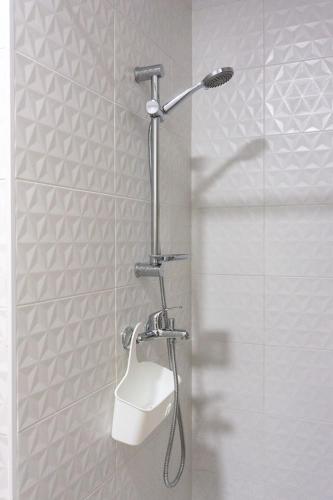 a shower with a shower head in a bathroom at Apartamentos La Ruta in Calpe