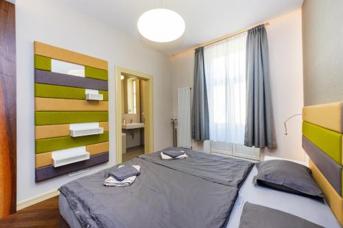 a bedroom with a large bed and a window at Bellevue Apartment in Prague