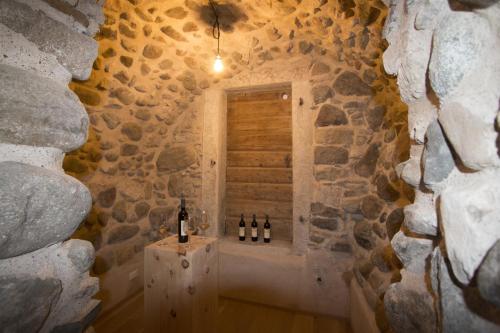 a room with a window with bottles of wine at Agriturismo La Ciasa Del Fabio in Tassullo