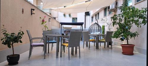 a table and chairs on a balcony with plants at Central West Hotel in Sofia