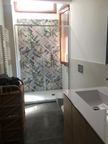 a bathroom with a shower with a glass door at Marie Home Florence in Scandicci