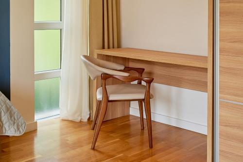 a chair sitting next to a desk in a room at 2montenegro MIMOZA Apartments in Dobrota