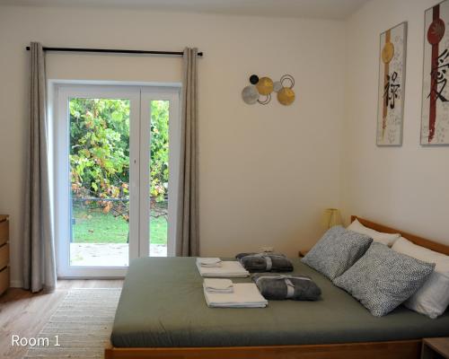 a bedroom with a bed and a door to a yard at Quiet, green, relaxing place- 3 bedroom villa in Balatonfüred