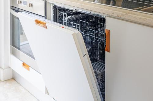 a dishwasher with its door open in a kitchen at Lisbon Sunny Terrace Lapa Santos in Lisbon