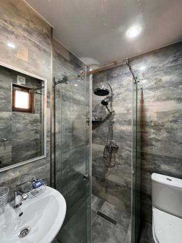 a bathroom with a shower and a sink at villa with beautiful view 3 in Tbilisi City