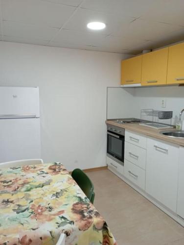 a room with a kitchen with a table and a sink at Gradina Apartment in Montana