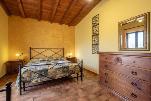 a bedroom with a bed and a dresser and a mirror at Sasso Bianco in Pitigliano