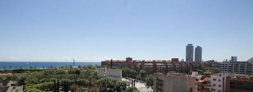 a view of a city with the ocean in the background at Hotel Best 4 Barcelona in Barcelona
