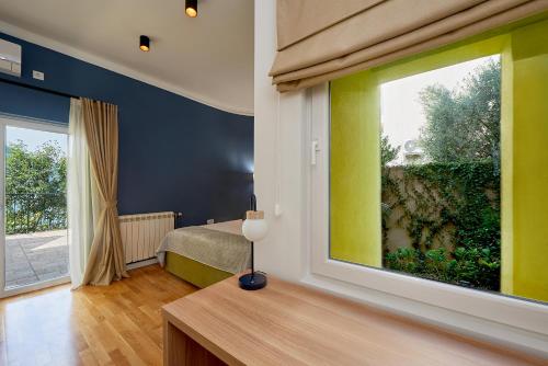 a bedroom with a large window and a bed in it at 2montenegro MIMOZA Apartments in Dobrota
