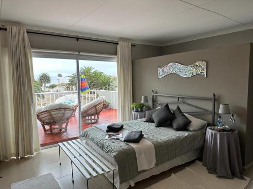a bedroom with a bed and a view of a patio at 19 Richthofen in Swakopmund