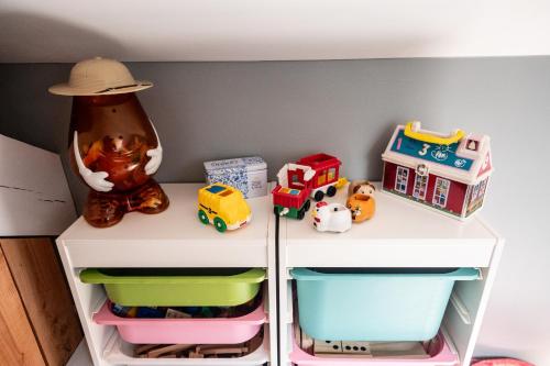 a shelf with toy cars and toys on it at L'arche De Noé in Dinant