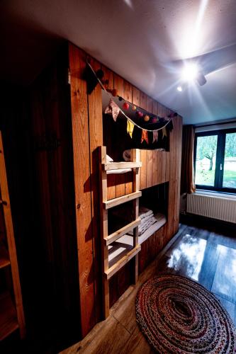 a room with a wooden wall with a ladder in it at L'arche De Noé in Dinant