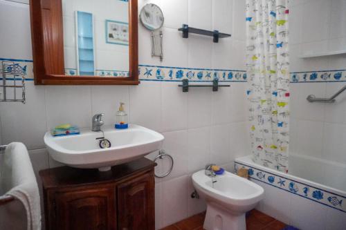 La salle de bains est pourvue d'un lavabo, de toilettes et d'un miroir. dans l'établissement Beach Breeze, Playa Santiago, à Alajeró