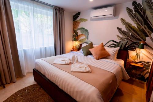 a bedroom with a large bed with towels on it at New Seahorse Residence in Nathon Bay