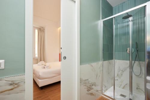 two views of a bathroom with a shower at DEM Hotel in Rome