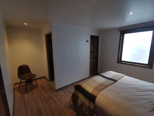 Ένα ή περισσότερα κρεβάτια σε δωμάτιο στο Hostal Licanantay
