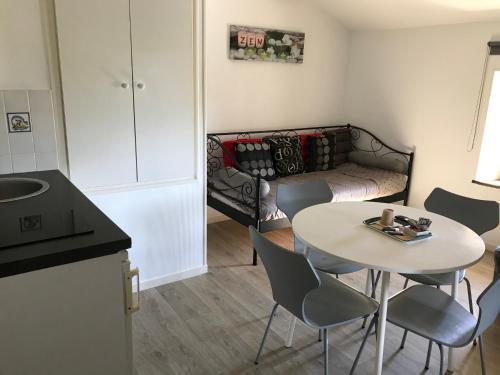 a small living room with a table and a couch at La Libaudière in Pouzauges