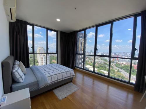 a bedroom with a bed and large windows at KL Gateway Penthouse w Karaoke by Cobnb in Kuala Lumpur