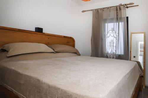 a bedroom with a large bed and a window at Cozy Seaside Paradise 3 min to Beaches in Bodrum in Bodrum City