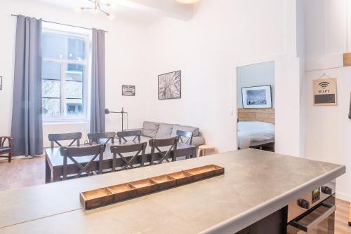a kitchen and living room with a table and chairs at La Vie est Belle - Entre ski et thermes in Ax-les-Thermes