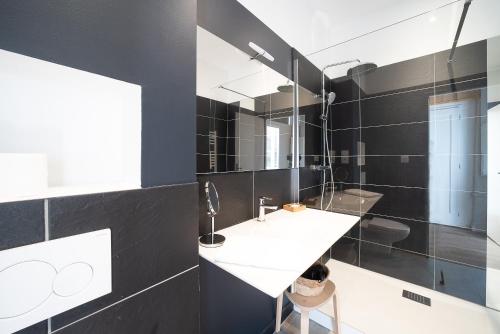 a bathroom with a sink and a mirror at La Vie est Belle - Entre ski et thermes in Ax-les-Thermes