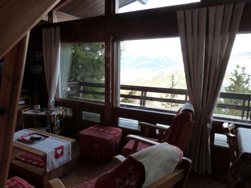 a living room with a view of a mountain at Chalet Cèdre Rouge in Enchastrayes