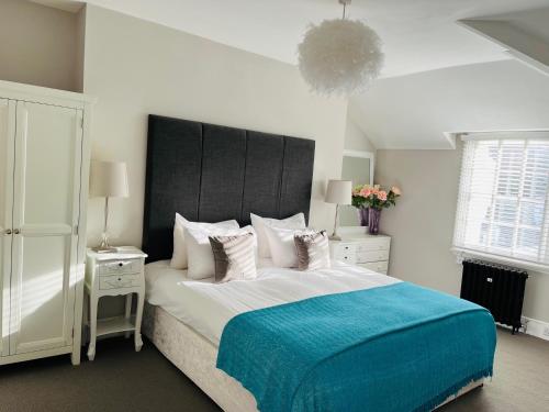 a bedroom with a large bed with a blue blanket at Number Nine Torquay in Torquay