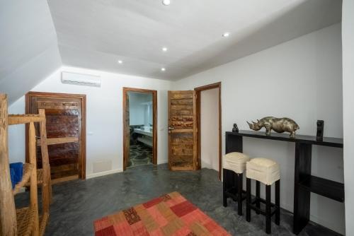 a living room with a table and stools in a room at Beachfront Villa Hideaway ZanzibarHouses in Kiwengwa