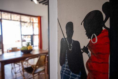 a painting of a woman on a wall in a room at Beachfront Villa Hideaway ZanzibarHouses in Kiwengwa