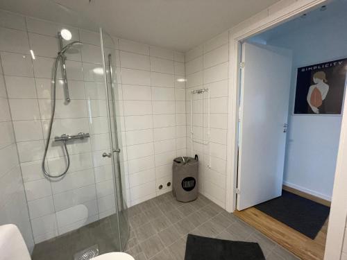 a bathroom with a shower with a glass shower stall at Feels Like Home in Gothenburg