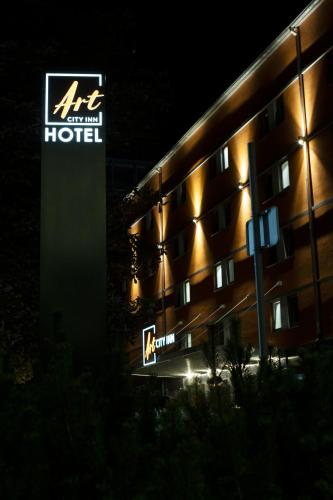 a hotel with a sign in front of it at Art City Inn in Vilnius