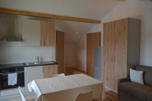 a kitchen and dining room with a table and a couch at FeWo Rotter Blick in Rott am Inn