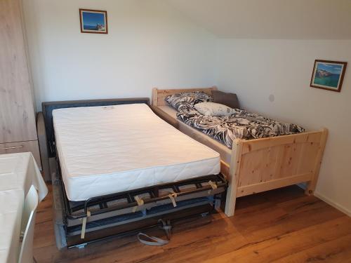 a bed sitting in a room next to a wall at FeWo Rotter Blick in Rott am Inn