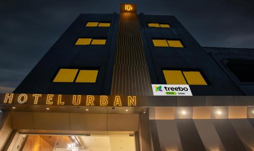 a hotel burj khalifa at night with a sign on it at Treebo Urban, 1 Km From Railway Station in Surat