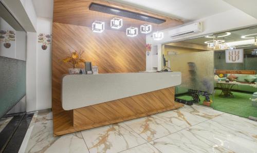 a lobby with a reception desk with a marble floor at Treebo Trend Urban in Surat
