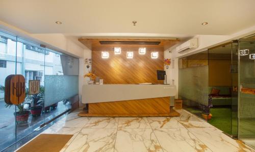 a lobby with a reception desk in a building at Treebo Urban, 1 Km From Railway Station in Surat