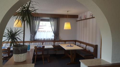 a dining room with a table and a window at Mountain Motel in Leutasch