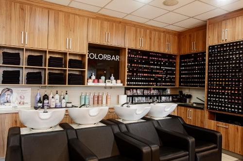 a bar with a bunch of chairs and bottles of wine at Rosengarten Hotel & Restaurant in Sopron