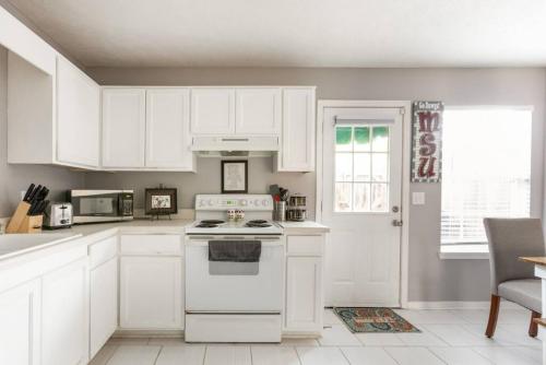 a kitchen with white cabinets and a white stove top oven at Bulldog Academy. Convenient to MSU. in Starkville