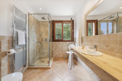 a bathroom with a sink and a glass shower at Villa Coloma in El Port