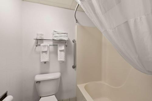 a white bathroom with a toilet and a shower at Best Western Germantown Inn in Germantown