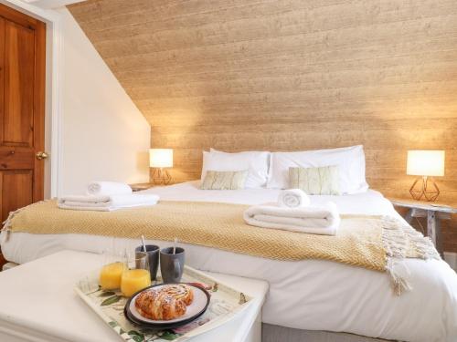 a hotel room with two beds with a breakfast on a table at Church View in Grange Over Sands