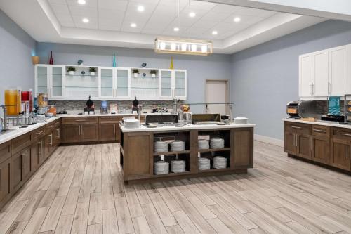 a large kitchen with wooden cabinets and white counters at Homewood Suites By Hilton San Marcos in San Marcos