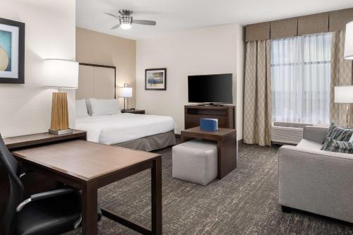 a hotel room with two beds and a couch at Homewood Suites By Hilton San Marcos in San Marcos