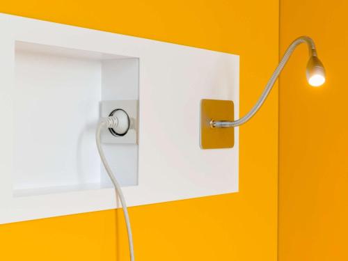 a lamp with a cord plugged into a lightswitch at ibis budget Manhuaçu in Manhuaçu