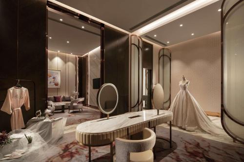 a dressing room with a wedding dress and a dressing table at Hilton Taizhou in Taizhou