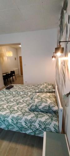 a bedroom with a bed in a room with a table at Apartamenty Częstochowa in Częstochowa
