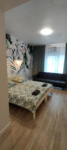 a bedroom with a bed and a couch in a room at Apartamenty Częstochowa in Częstochowa